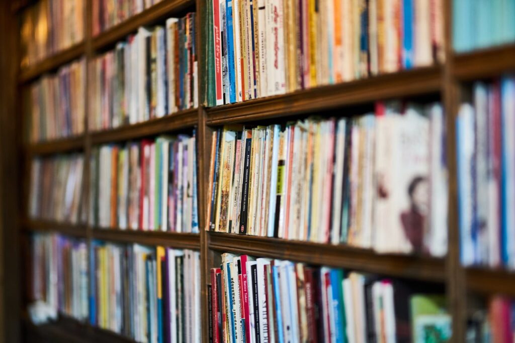 pexels-photo-2943603 A detailed close-up view of a bookshelf in a library, showcasing various books.