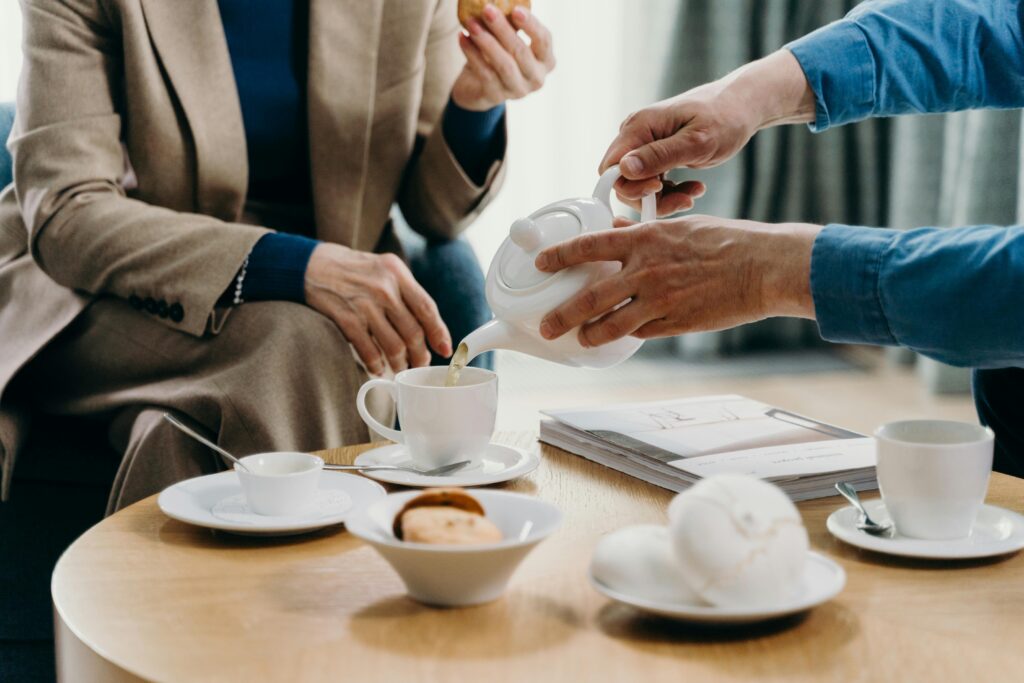 A cozy indoor setting featuring tea and cookies on a wooden table, perfect for connection.